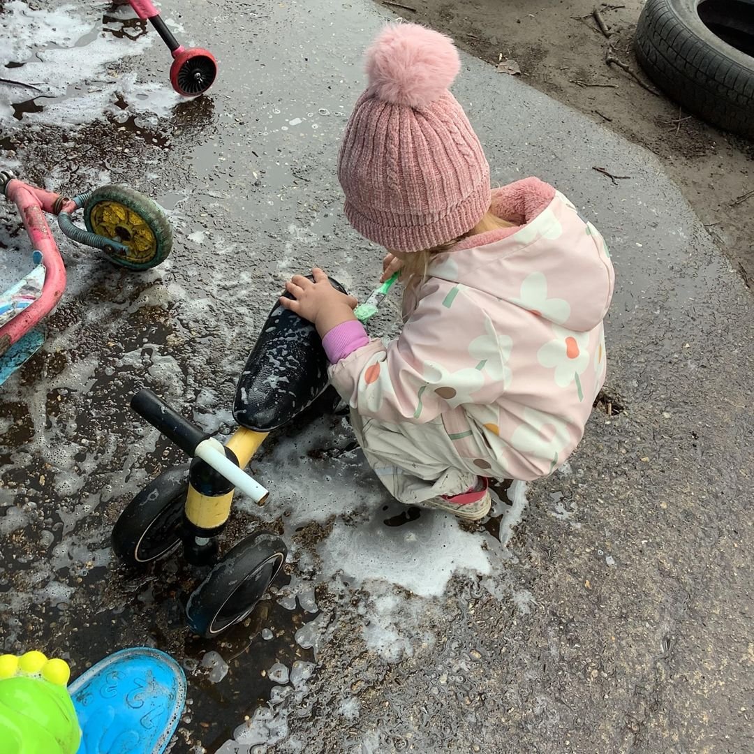 A child washing the bikes outdoors