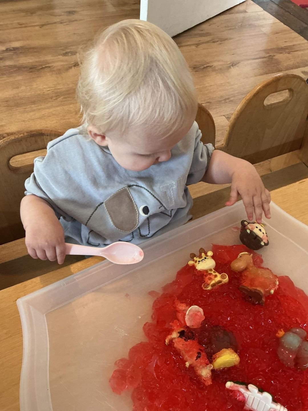 A toddler exploring jelly sensory play