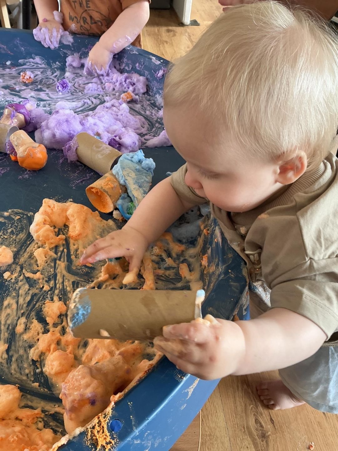 A baby exploring messy play